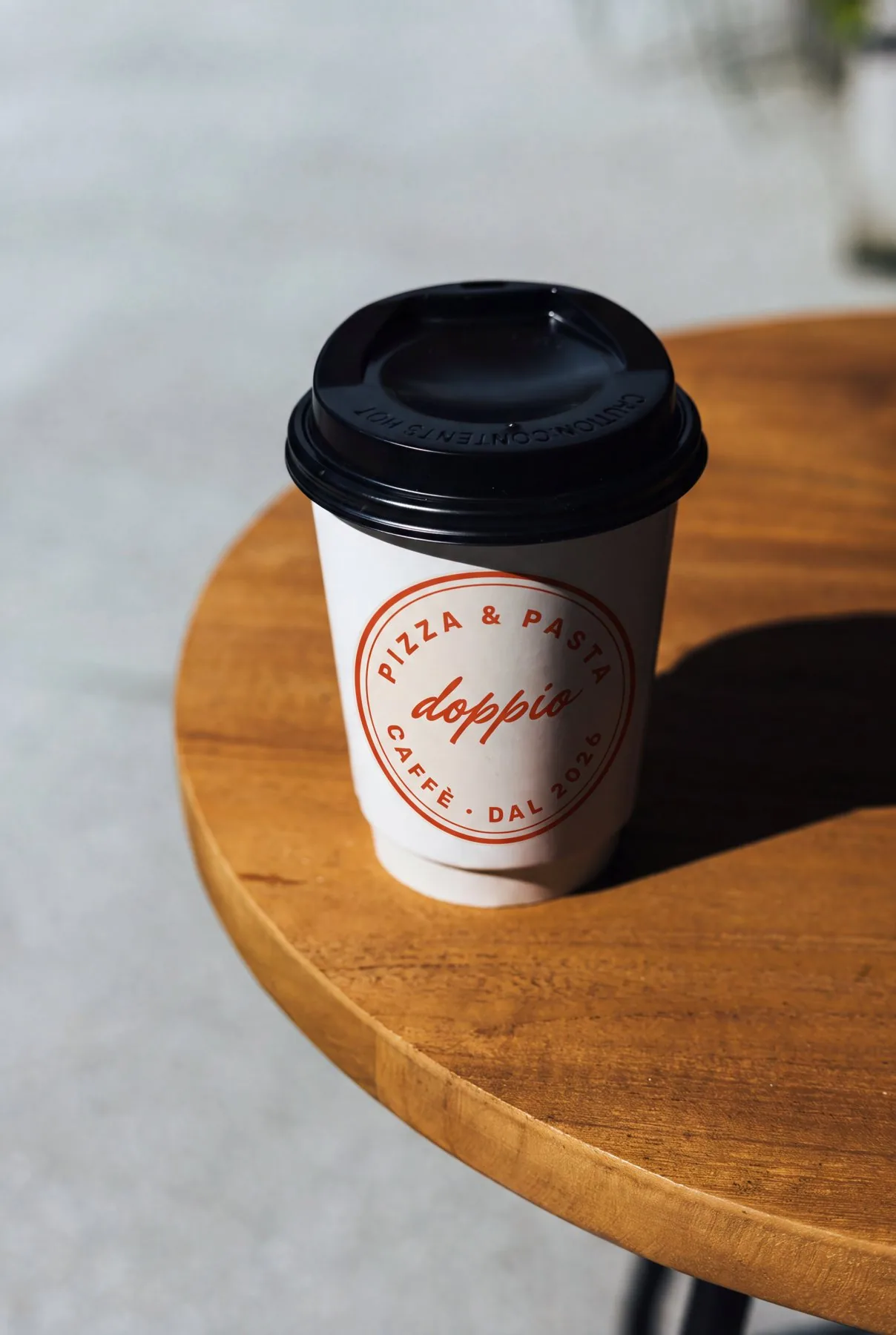 Coffee cup with the round seal on a café table
