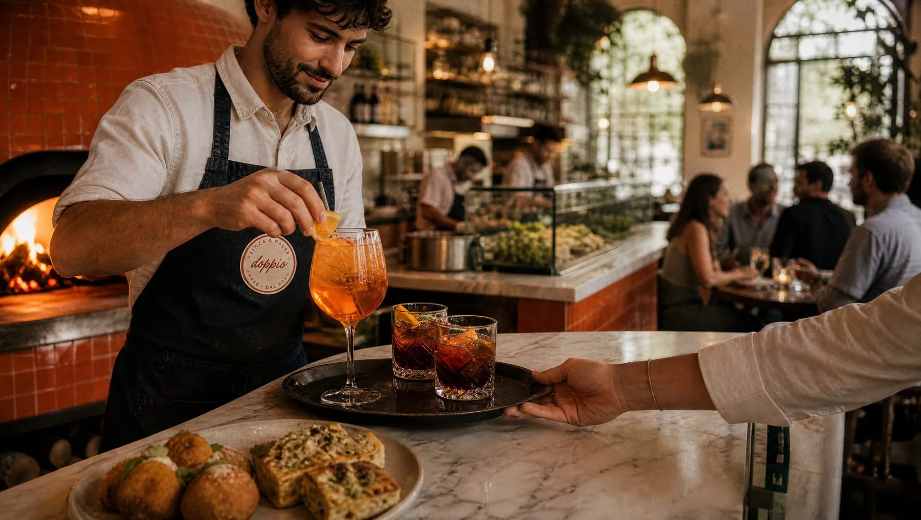 Bartender in the apron preparing an Aperol spritz